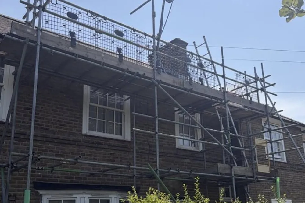 Scaffolding at roofline height with debris netting fitted