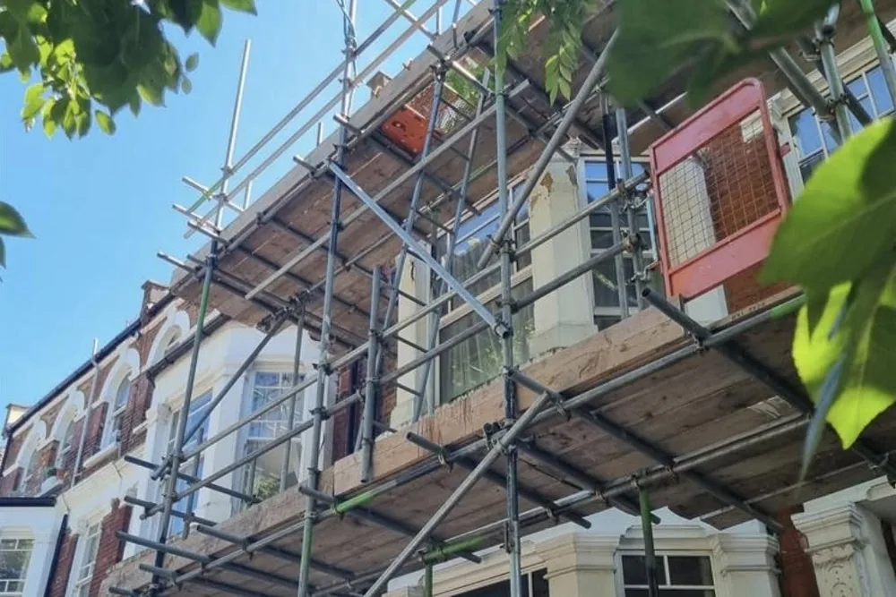 Scaffolding rising up the front of a period terrace